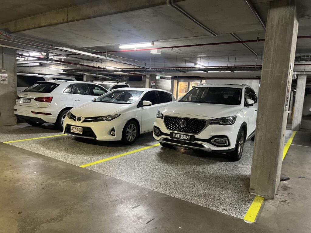 Secure underground car parking at Honeysuckle Executive Apartments with clearly marked yellow bays