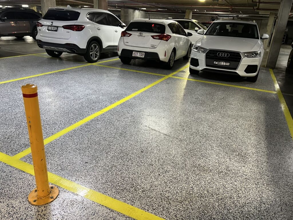 Secure underground car parking at Honeysuckle Executive Apartments with clearly marked yellow bays