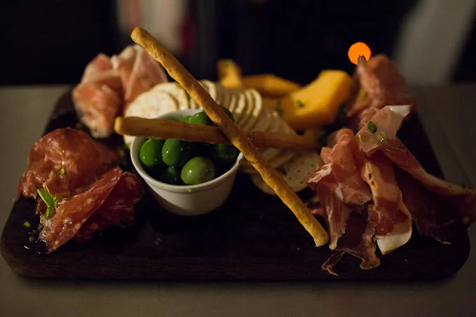 Coal and Cedar charcuterie board with meats, cheeses and crackers near Honeysuckle Apartments Newcastle