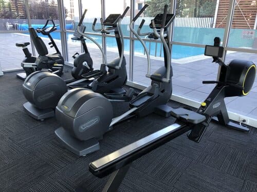 Modern fitness gym with cardio machines and rowing equipment at Honeysuckle Apartments Newcastle.