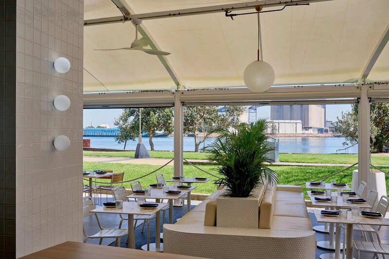 Waterfront dining at The Kingfish Restaurant near Honeysuckle Apartments with scenic harbour views.