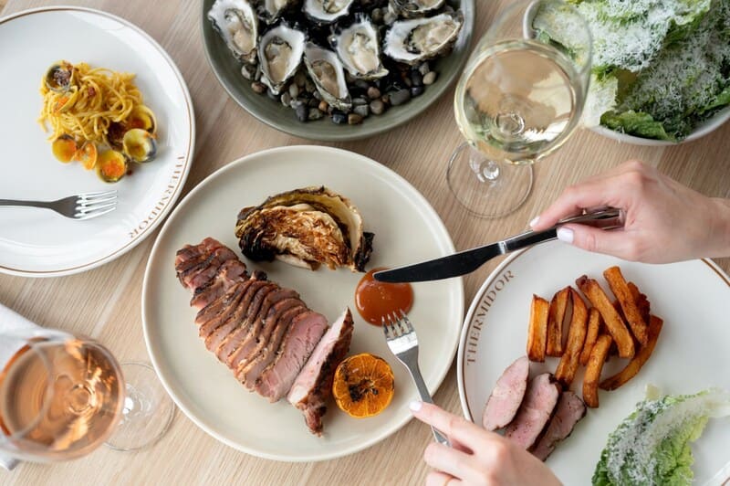 Fine dining at Thermidor AU with seafood, steak, wine near Honeysuckle Apartments.